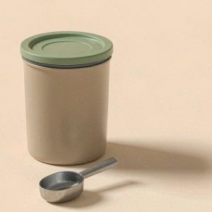 Illustration of an airtight pet food storage container with a scoop